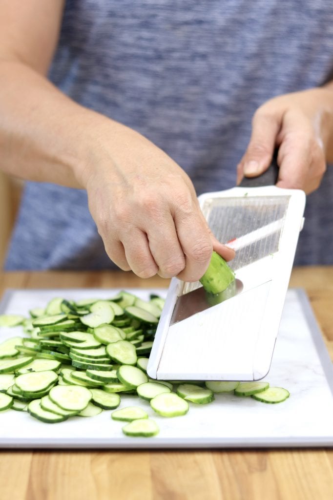 Slicing cucumbers with a mandoline slicer
