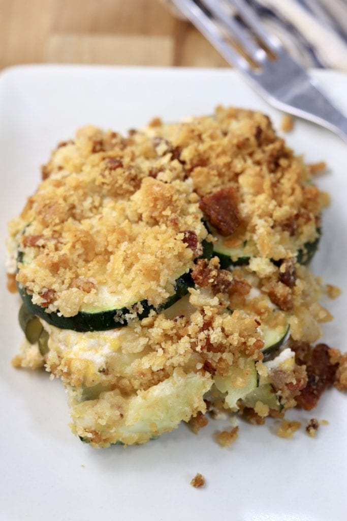 Zucchini jalapeno popper casserole with cracker topping on a plate
