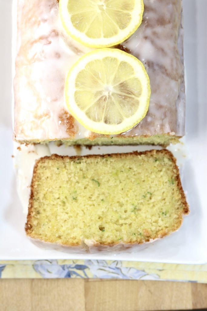 Lemon Zucchini Cake with glaze - one slice off of the loaf