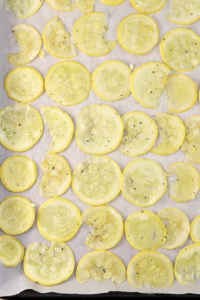 Parmesan Squash Chips Sliced squash on a baking sheet