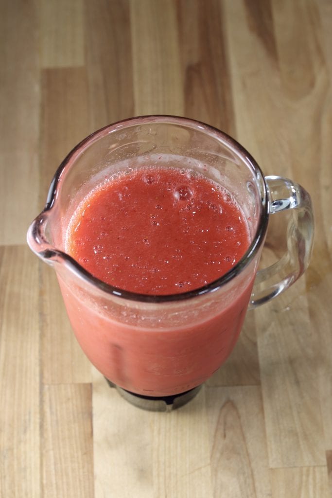 Blended strawberry lemonade in a blender pitcher