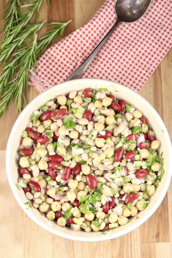 Red napkin with bean salad in a bowl