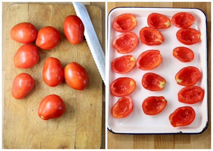 Roma tomatoes on a cutting board and sliced in half on a baking sheet with core and seeds removed