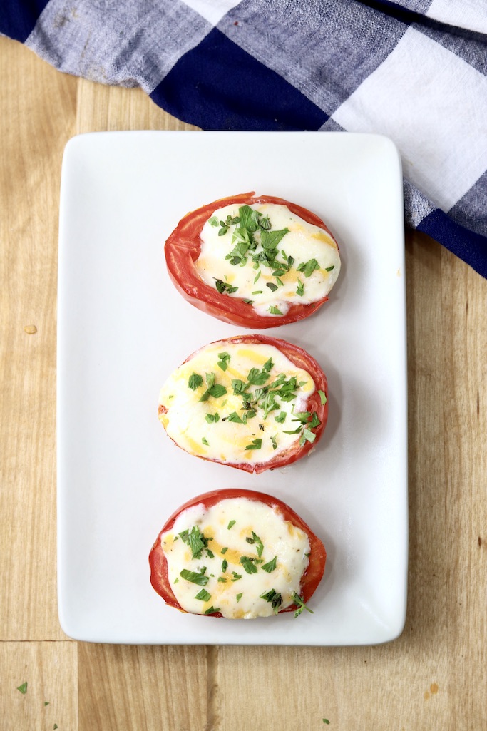 Baked Tomatoes with cheese filling - 3 on a rectangular appetizer plate