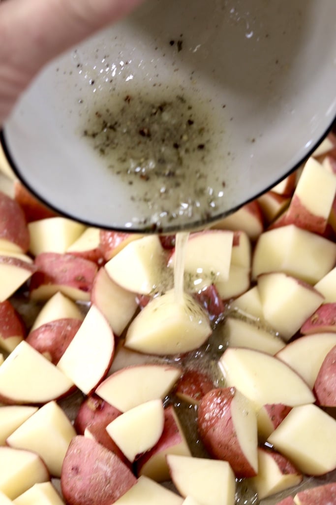 drizzling potatoes with oil and seasonings