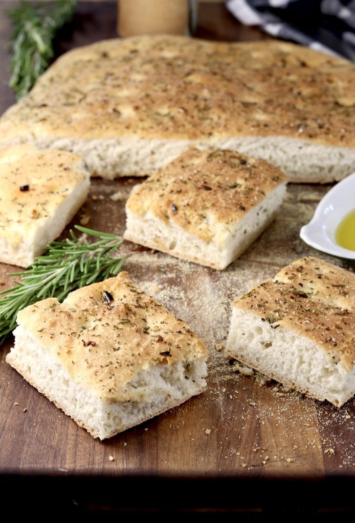 Slices of rosemary focaccia bread on a cutting board