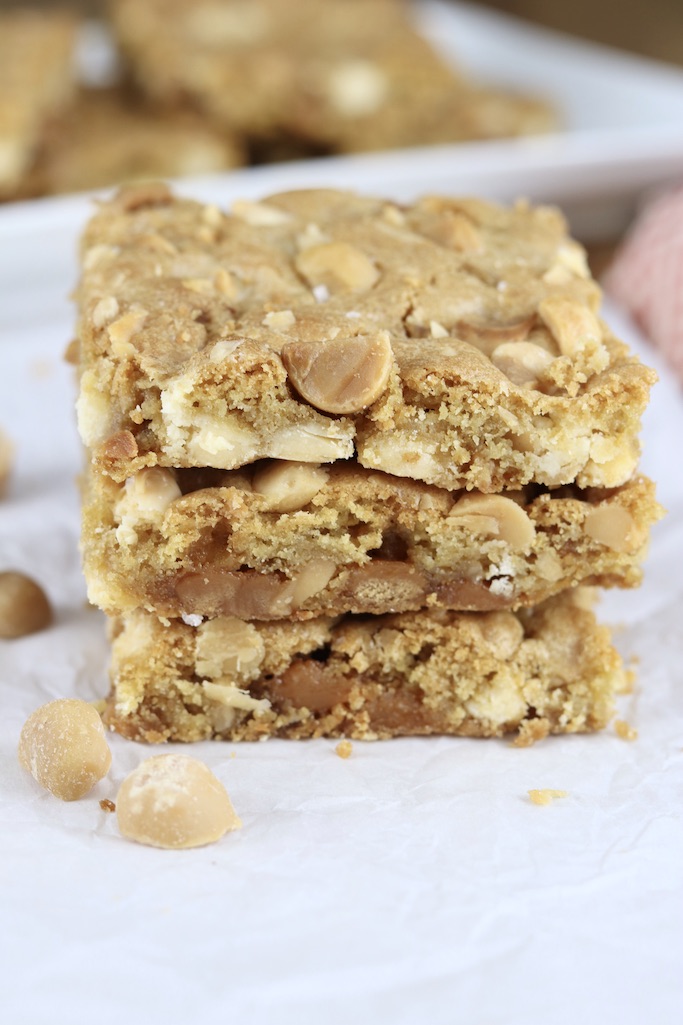 Cookie Bars with white chocolate, caramel and macadamia nuts stacked 3 on a plated