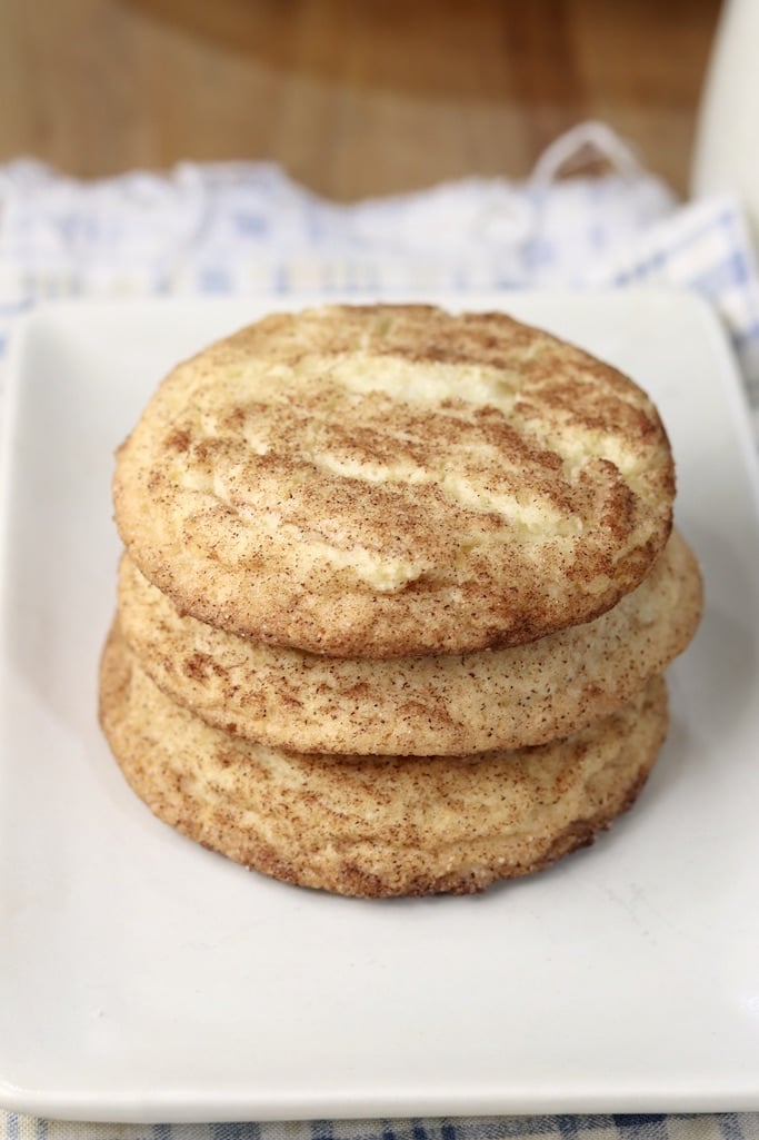 3 snickerdoodles stacked on a white plate