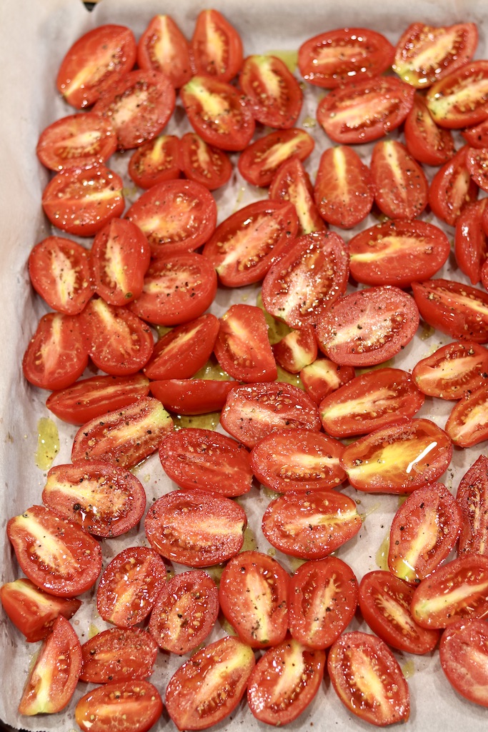 Seasoned tomato halves on a sheet pan