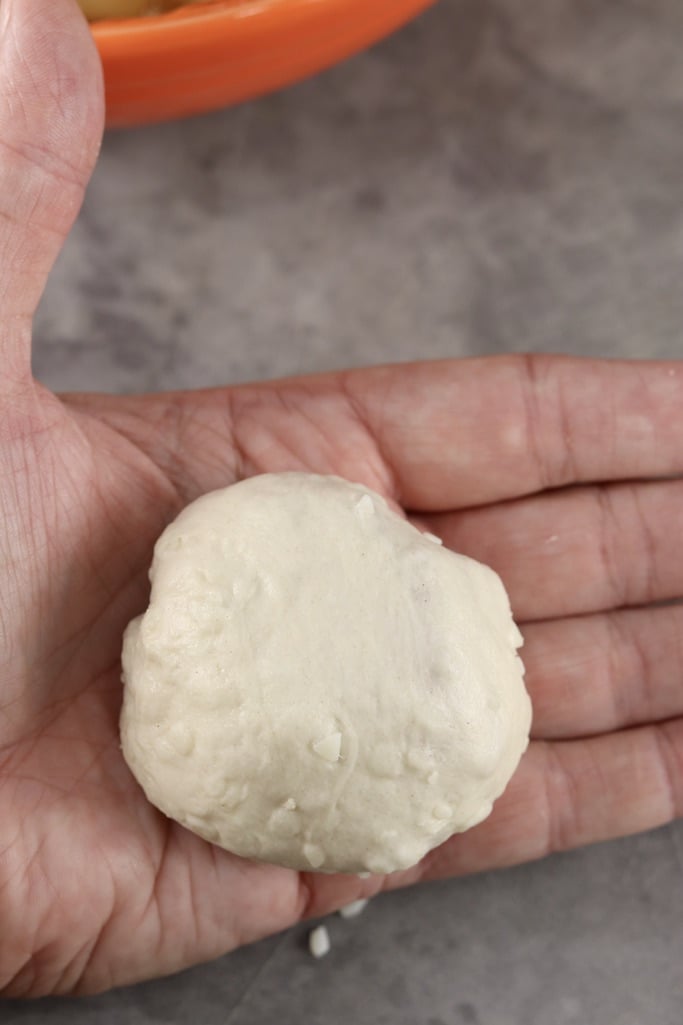 biscuit apple pie bomb dough in palm of hand