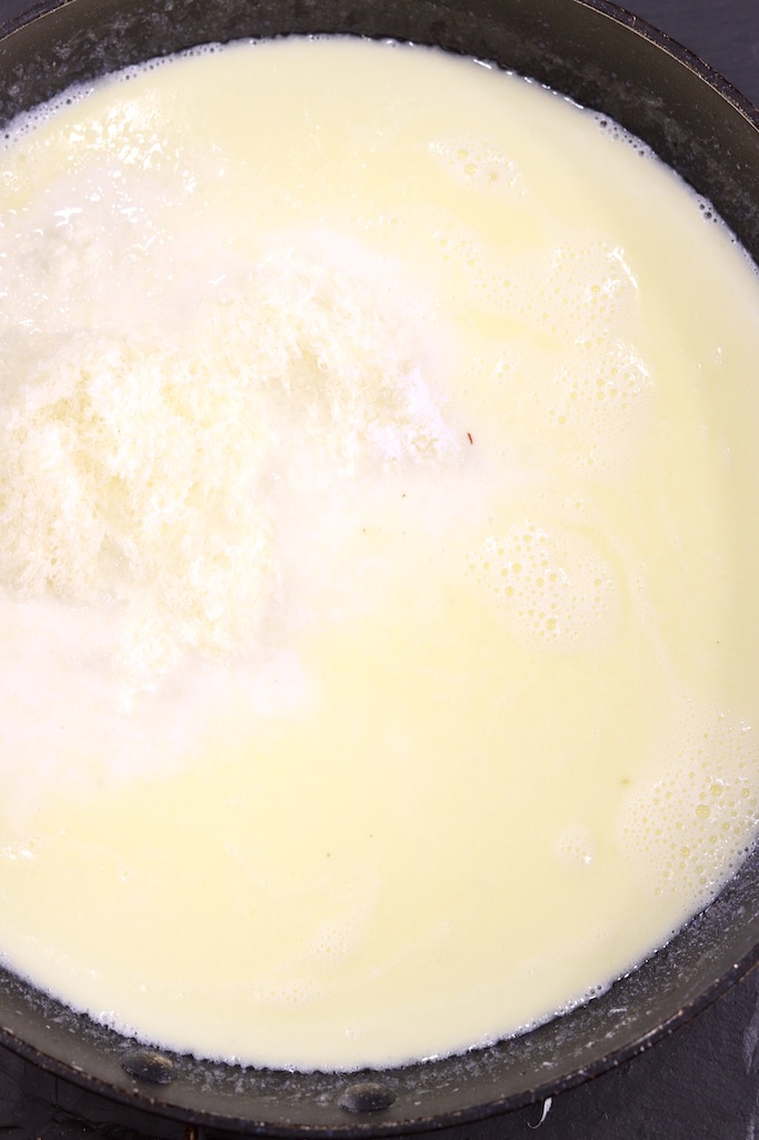 Making Alfredo sauce with cream and butter
