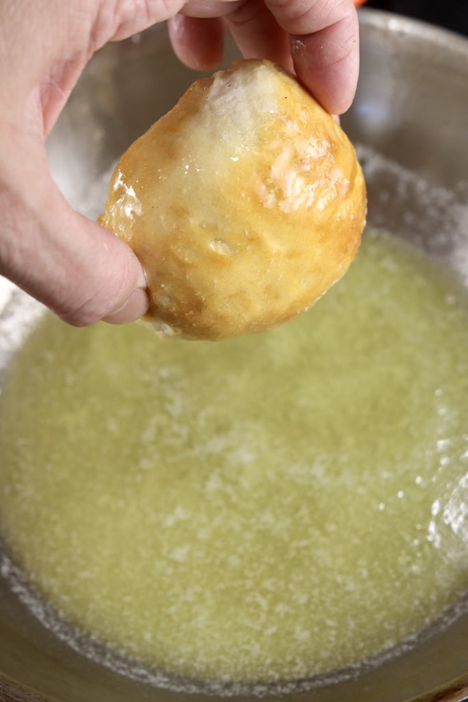 Dipping apple pie bomb in butter