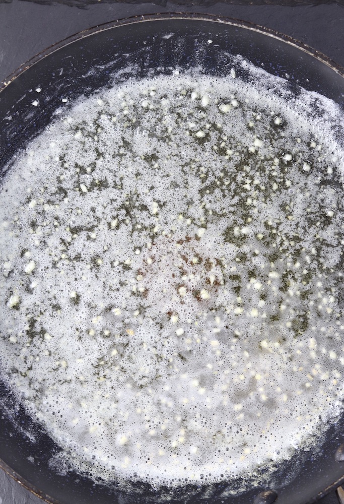 skillet with butter and minced garlic for Alfredo sauce