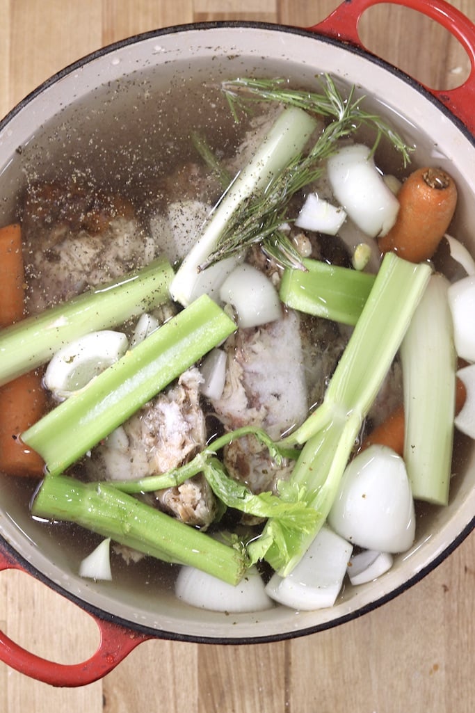 Pan with celery, carrots, onion and chicken carcass to make stock.