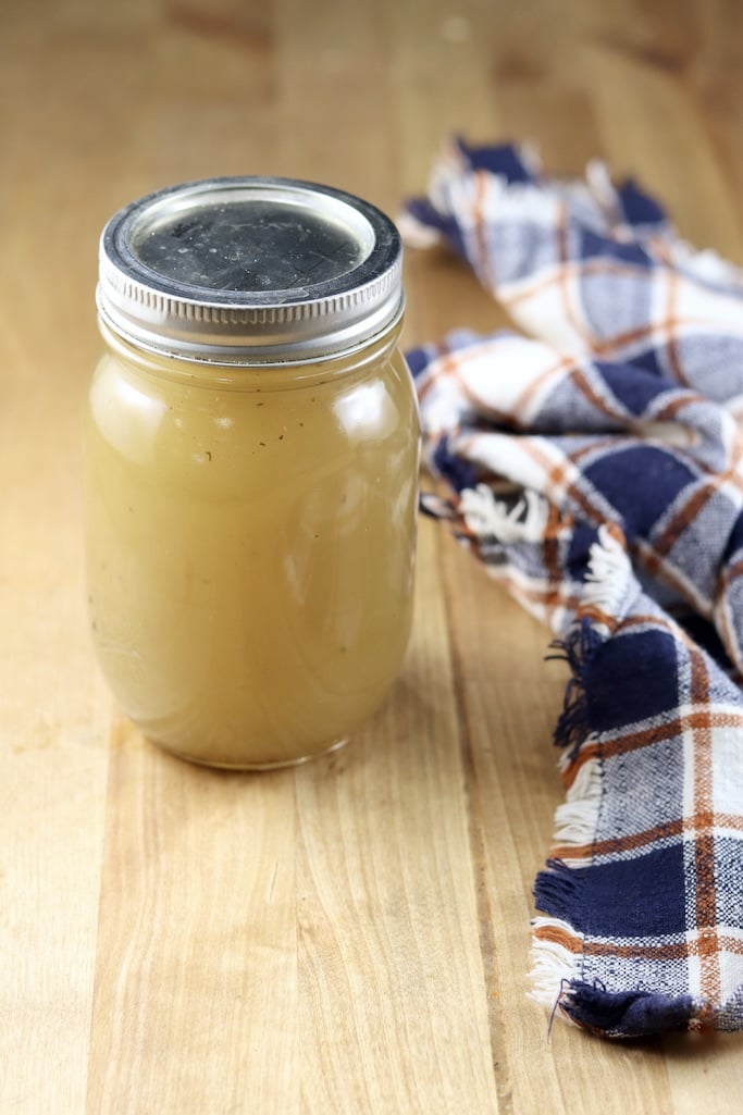 Jar of chicken broth with a blue plaid napkin