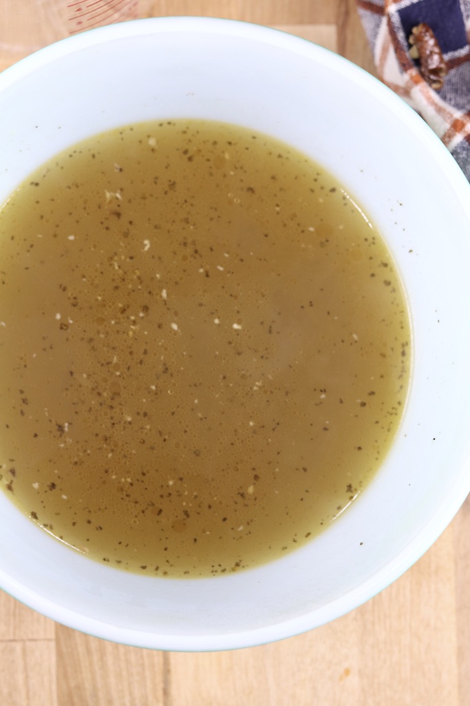 Rich chicken broth in a bowl - overhead view