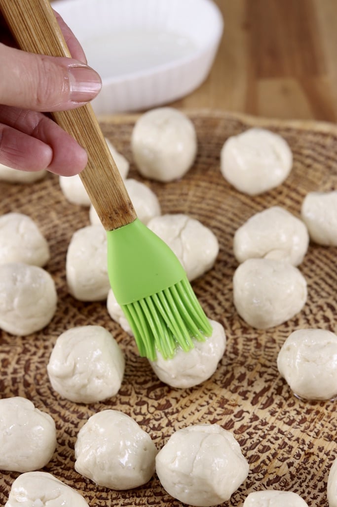 Brushing oil over dough balls before air frying