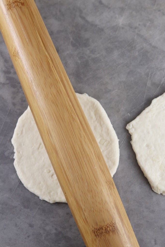 rolling pin rolling biscuit dough