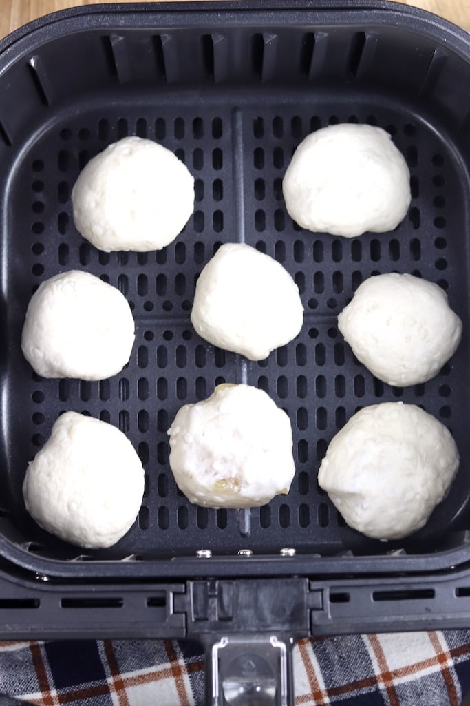 Air fryer basket with 8 apple pie bomb dough