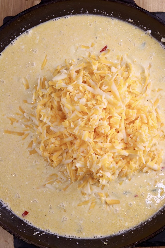 Adding shredded cheese to sauce for chicken spaghetti
