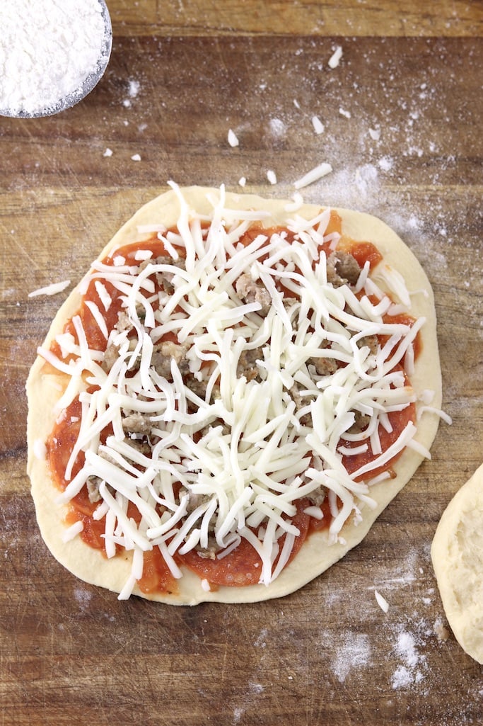 Mini biscuit pizza with pepperoni, sausage and shredded cheese