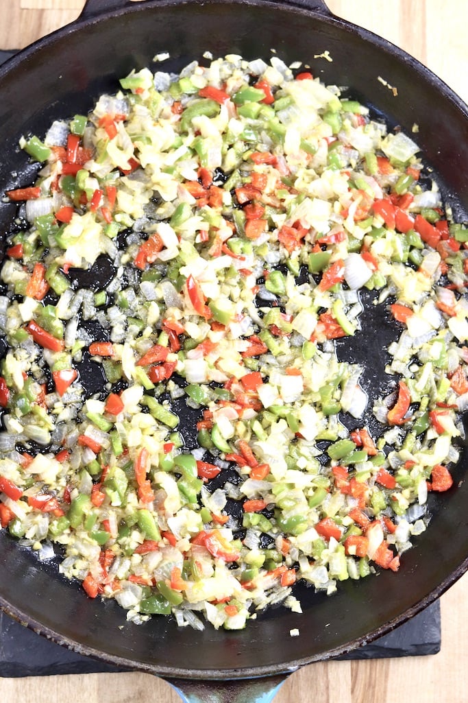 skillet with cooked diced onions, bell peppers and garlic