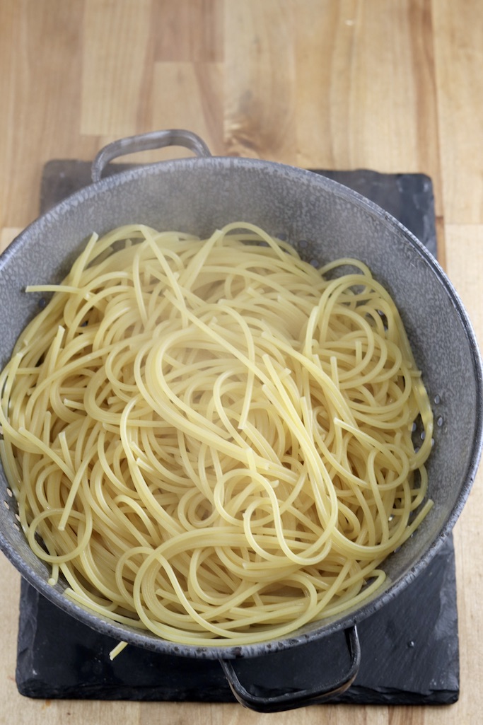 Colander of cooked and drained spaghetti