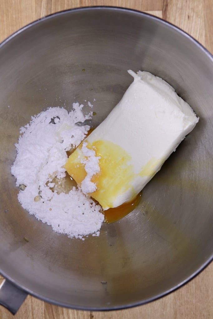 Bowl with cream cheese block, powdered sugar, vanilla, egg yolk
