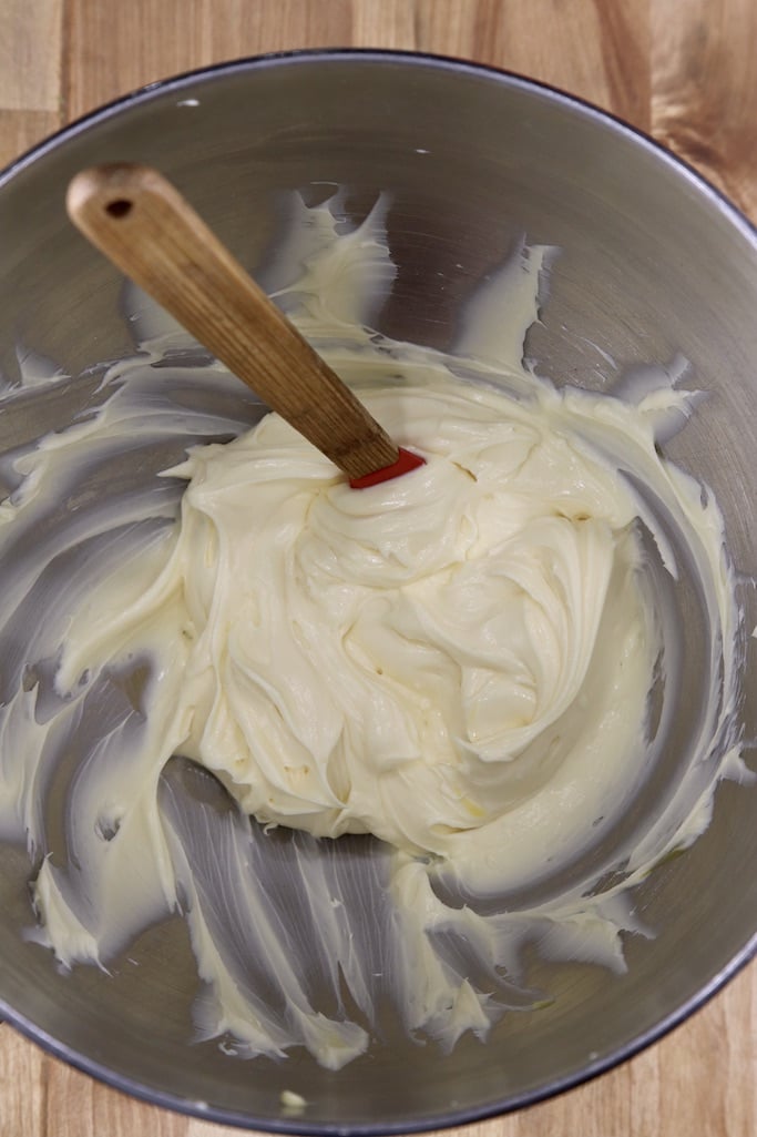 Cream cheese filling in a bowl with a spatula for cheese danish