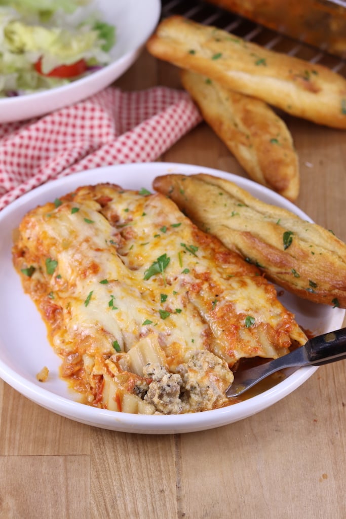 Plated manicotti stuffed with sausage and cheese