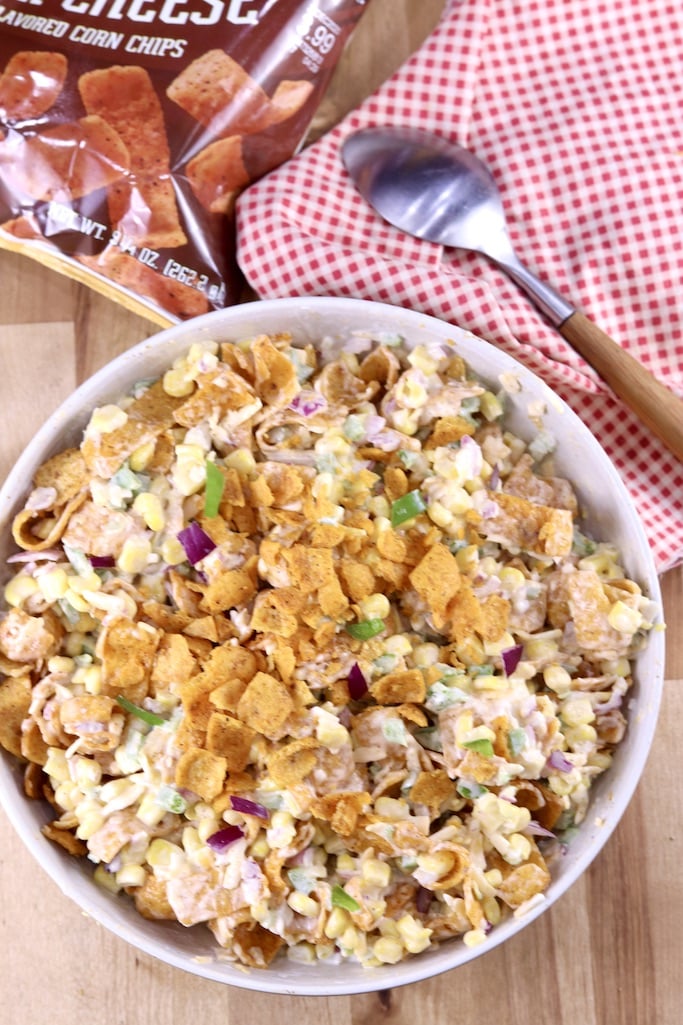 Frito Corn Salad Recipe in a bowl with red napkin and spoon