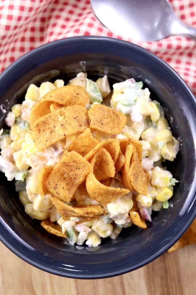 Bowl of corn salad topped with Fritos