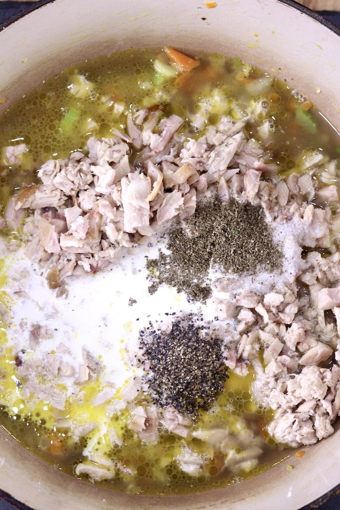 Dutch oven with chicken soup mixture, cream, broth, chicken and spices