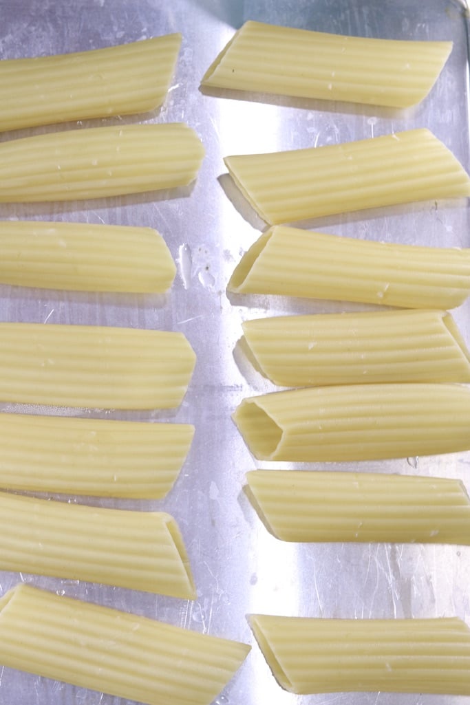 cooked manicotti pasta on a sheet pan