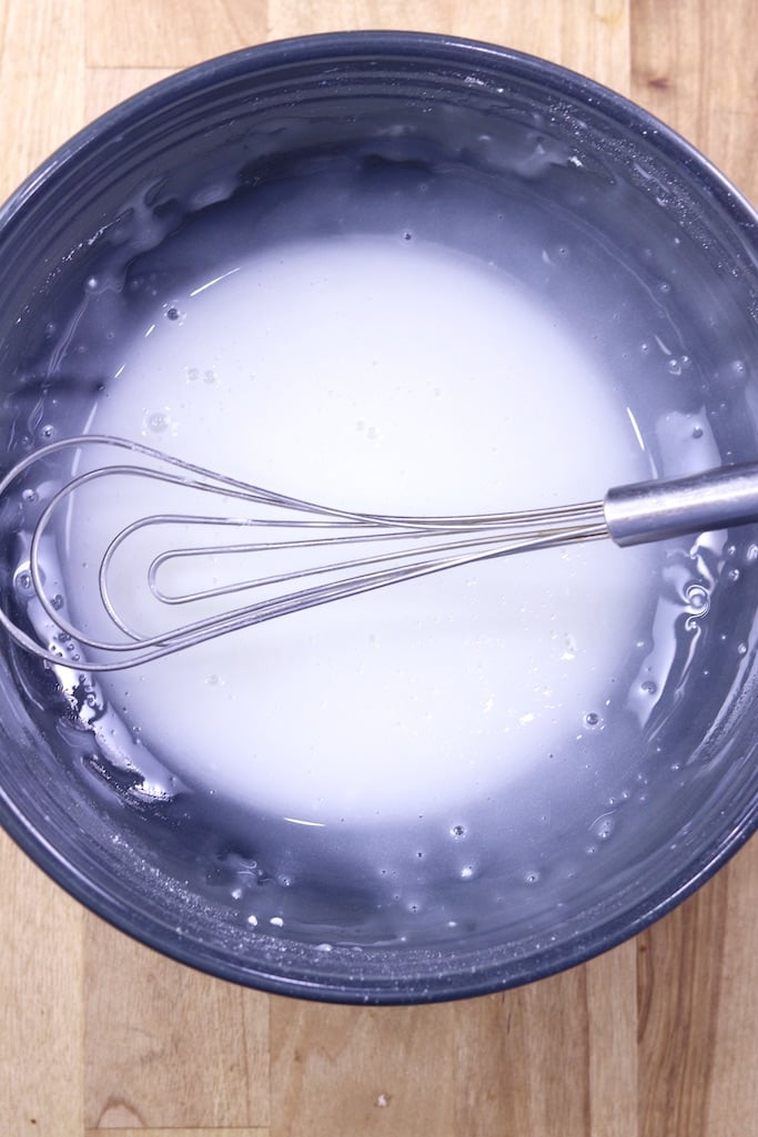 Powdered Sugar icing in a bowl with a whisk