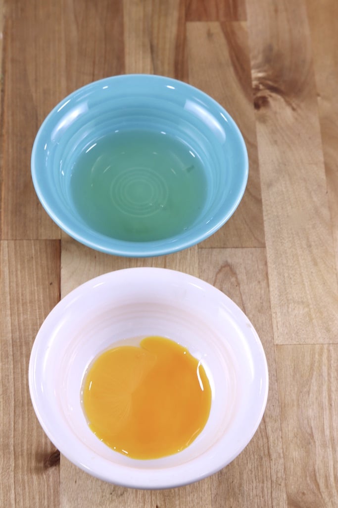 blue bowl with egg white, white bowl with egg yolk
