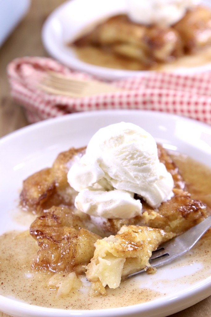 plated apple dumplings with vanilla ice cream with a fork