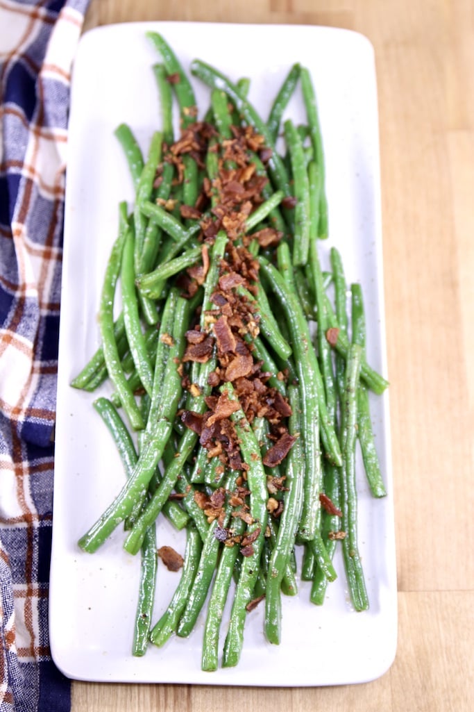 Bacon and green bean side dish on a platter - overhead view
