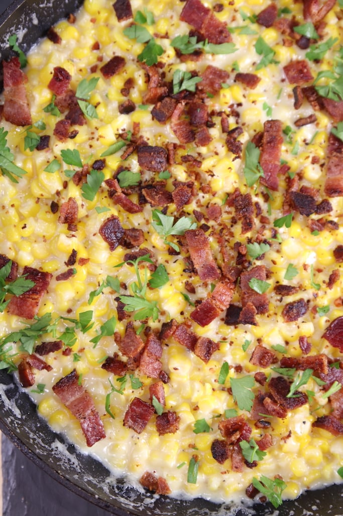 Bacon topped cream corn in a skillet