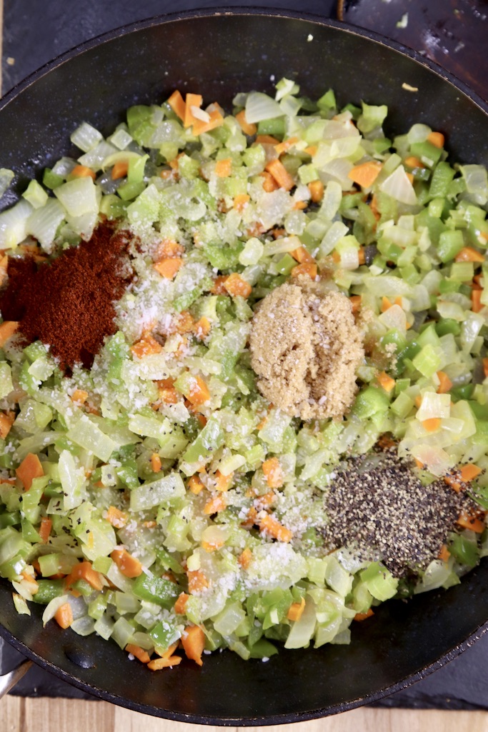 cooked vegetables in a skillet with seasonings