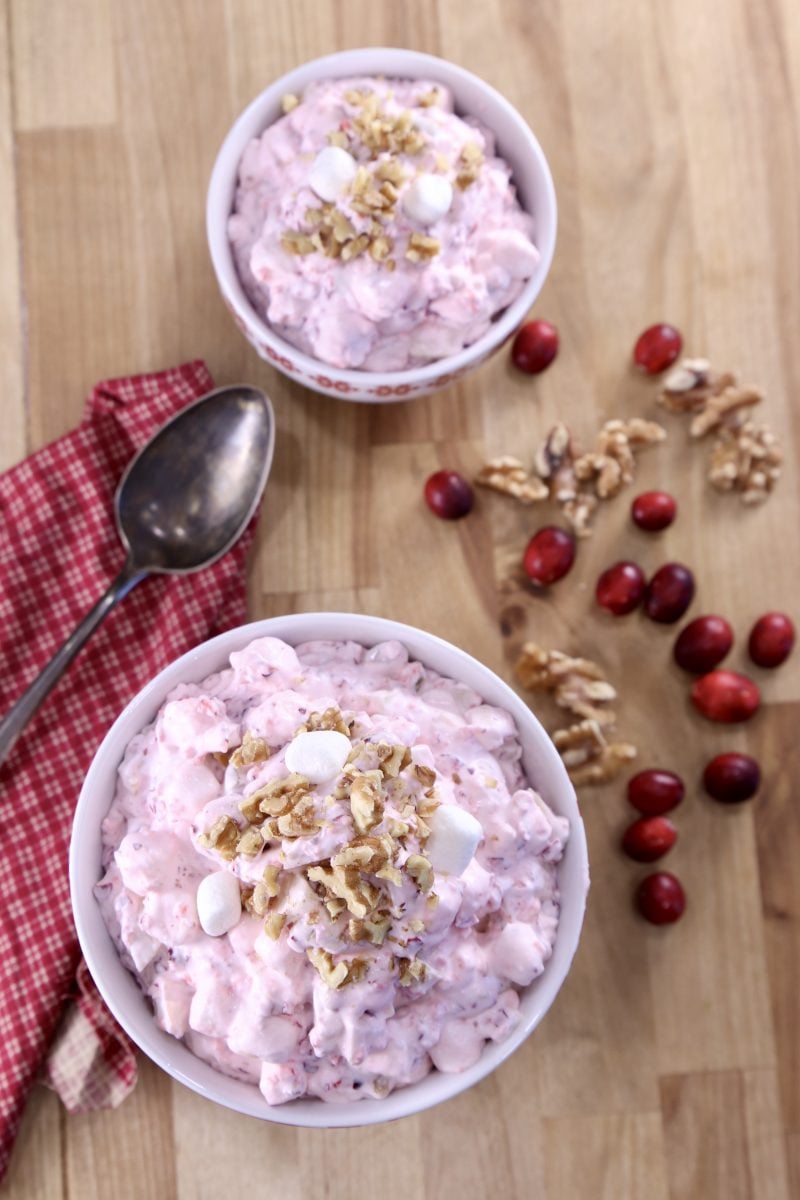 Cranberry Fluff in 2 bowls, cranberries and walnuts to the side