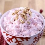 Cranberry Fluff Salad with walnuts in a snowflake red and white bowl