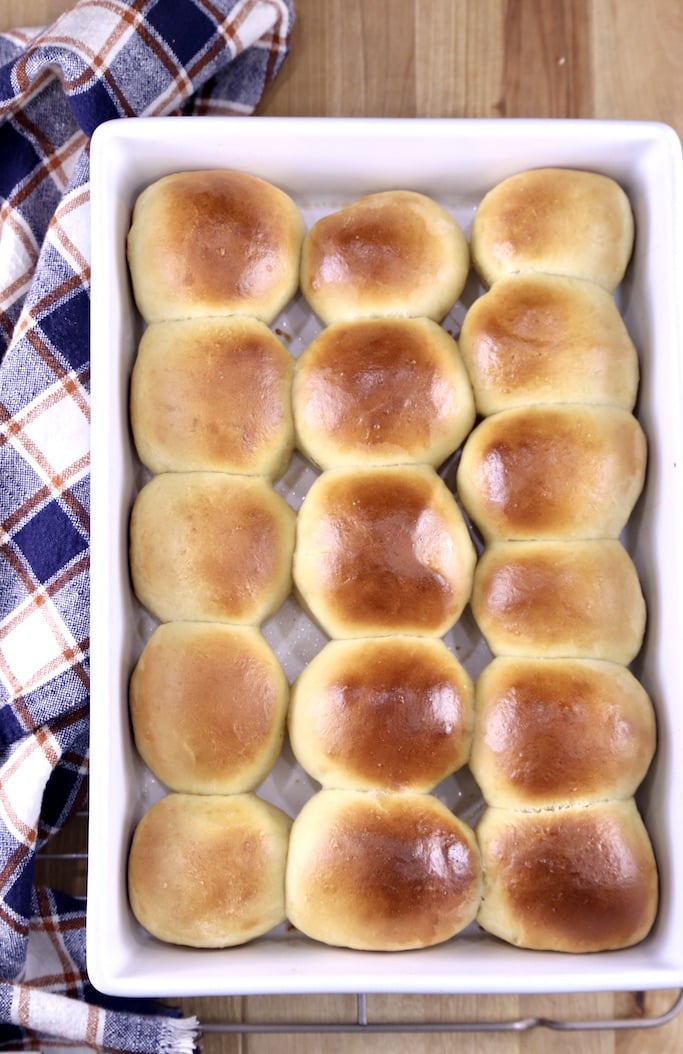 overhead view of pan of Hawaiian dinner rolls with a plaid towel