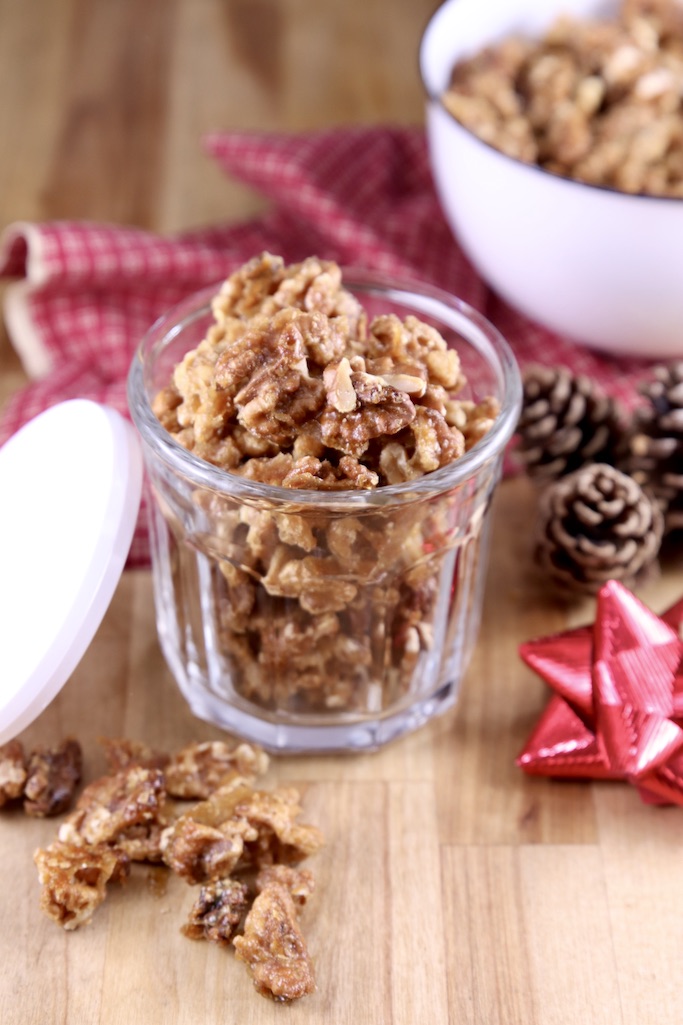 Candied walnuts in a small jar and a bowl, red bow to the side