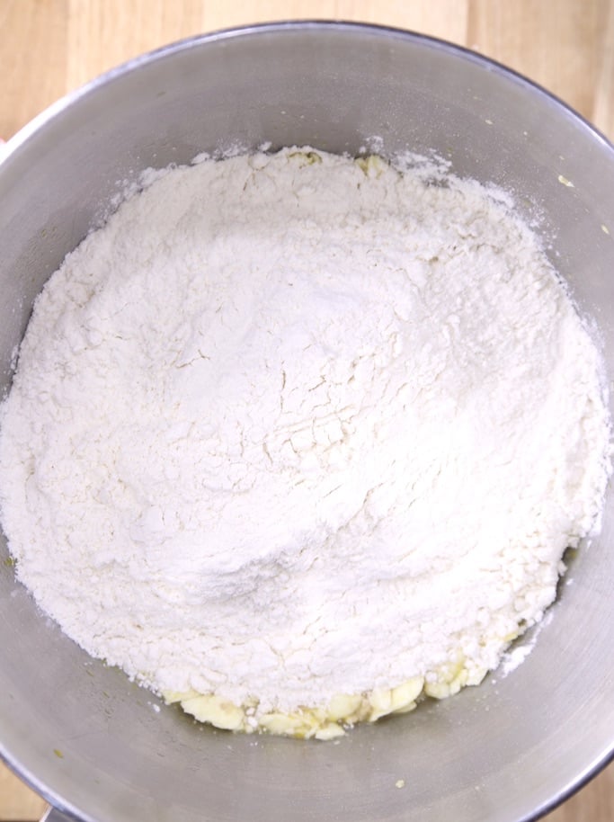 Adding flour to dinner roll mixture