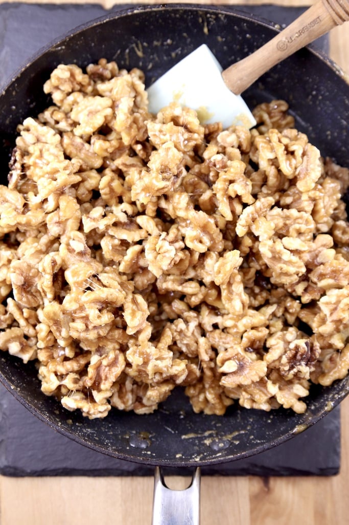 Candied Walnuts in a skillet with a spatula