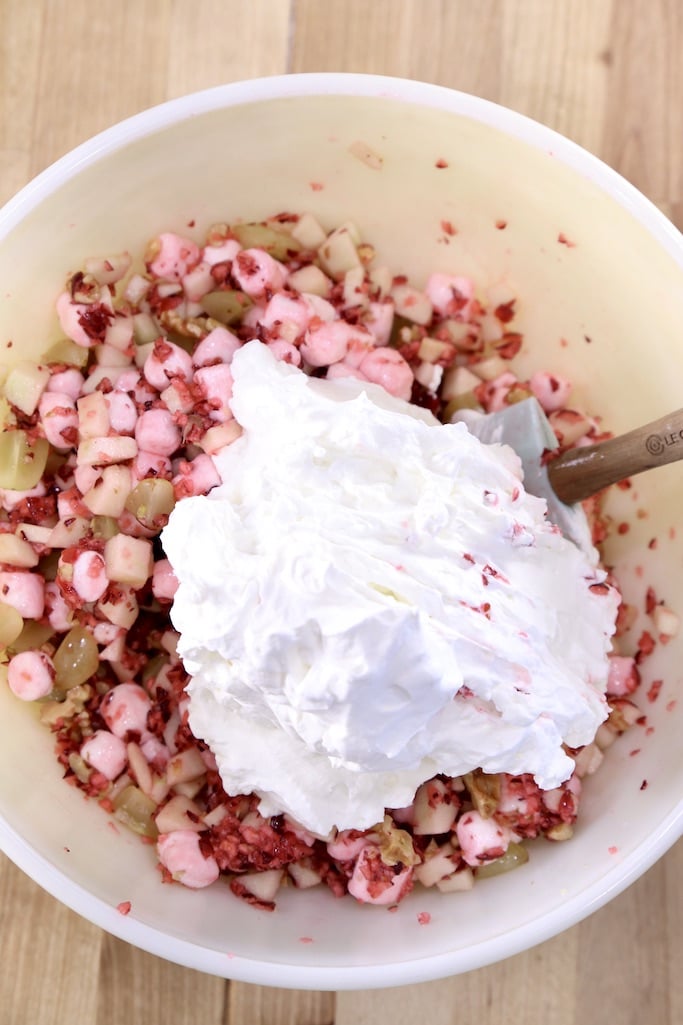 Bowl of cranberries and apples with whipped cream 