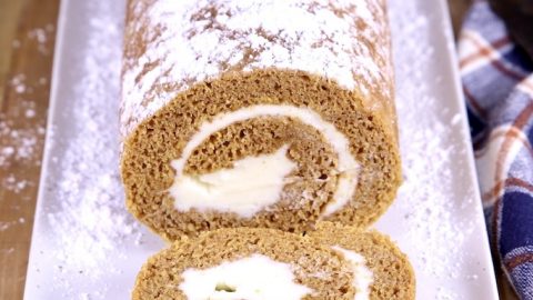 Pumpkin Roll with one slice off on a platter