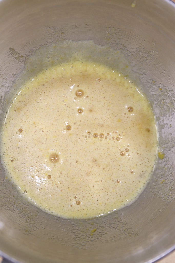 Eggs, sugar and vanilla mixed in a silver bowl