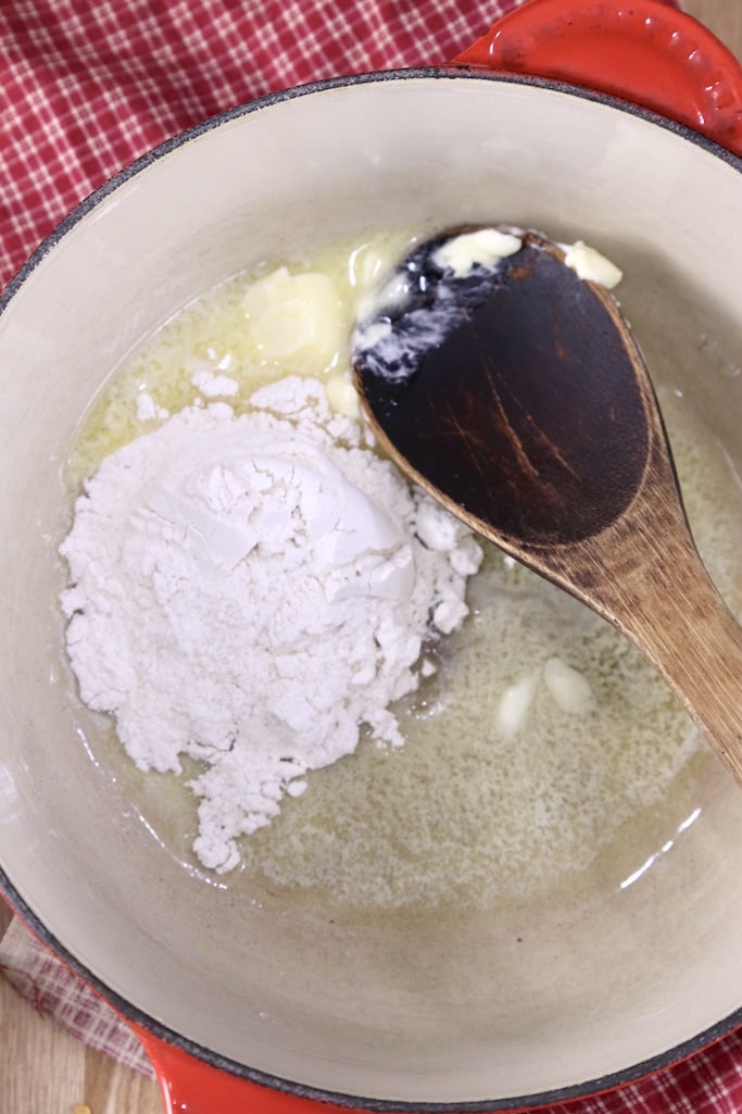 pan with melted butter, flour and a wooden spoon